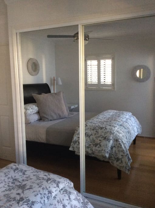 Double mirrored wardrobe featuring both hanging and shelf space.