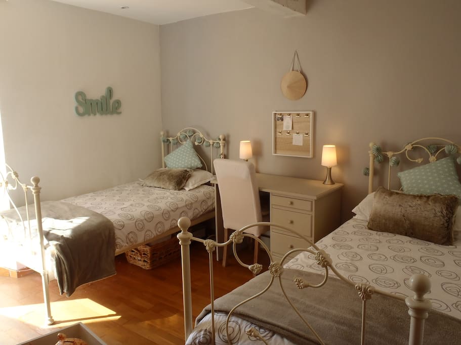 Bedroom with two single beds and large desk. Air-con.