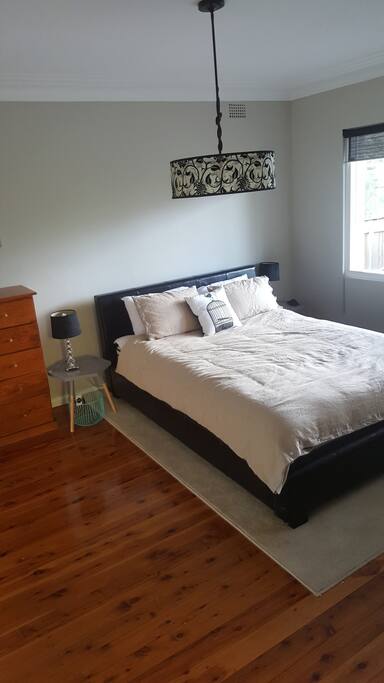 Queen bedroom with ample cupboard space bookshelf and desk. Large enough for a single mattress on the floor