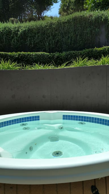 Relax in the 6 person hillside spa!