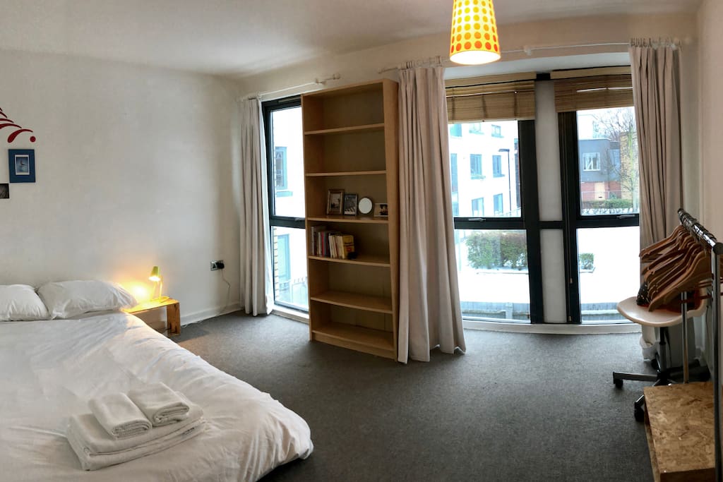 A quiet double bedroom with three floor to ceiling windows for plenty of light.