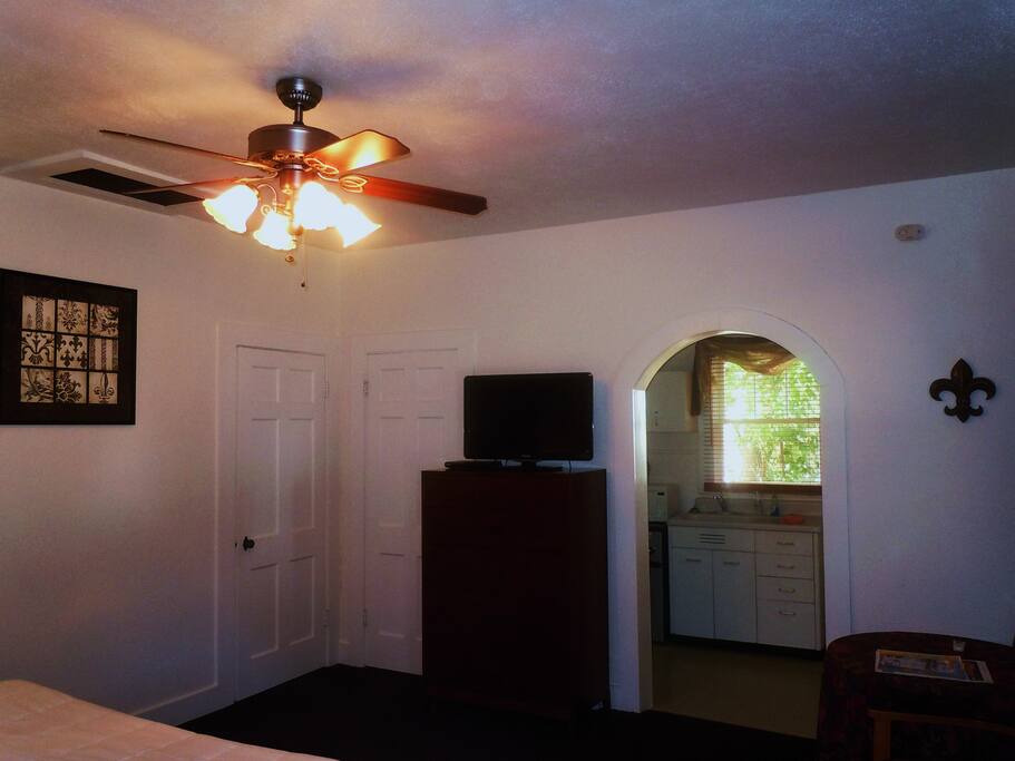 Showing archway to kitchen, TV, closet and bathroom.
