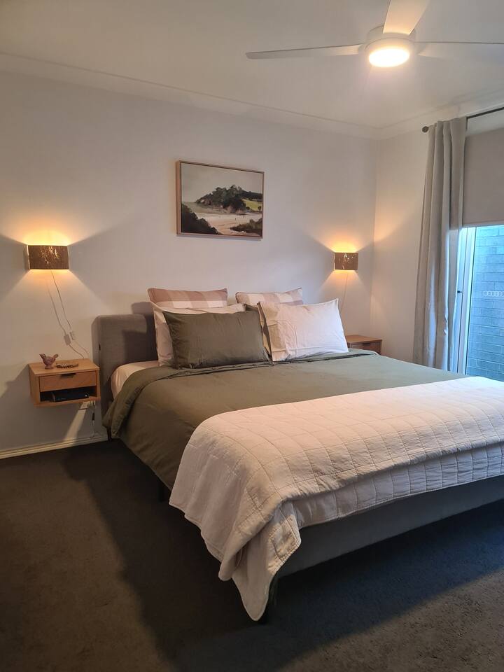 A king bed and Ecosa foam mattress with high quality 'Cannginvale' linen for a restful sleep. Overlooks a small outdoor alfresco and brings natural light in.