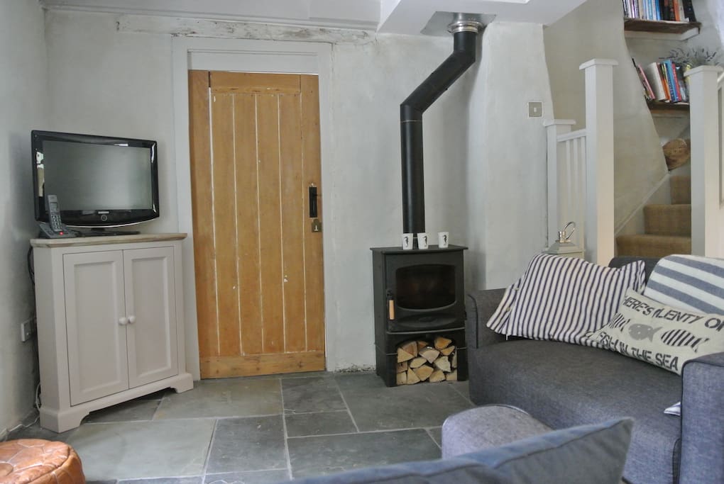 Open plan living room with comfy sofas and log burner