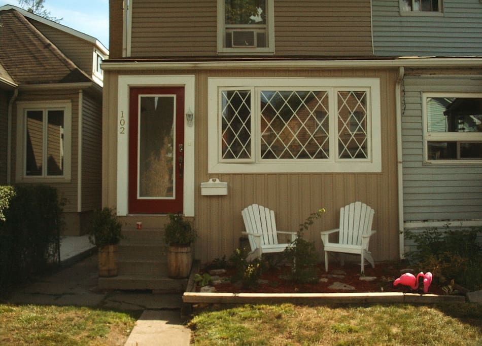 This is the front of the house in June 17. It is a cute semi in Central Hamilton circa 1900 that was completely renovated 2015-7. It includes a small rose garden with wooden muskoka chairs that overlooks the front yard and neighbourhood. Your entrance is to the left and around the house.