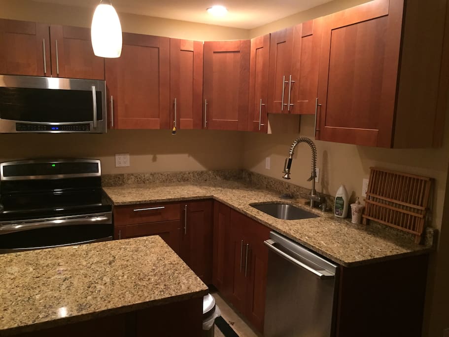Stainless steel appliances (Microwave, glass stovetop, dishwasher, and coffee maker). High end cabinets and granite countertops.