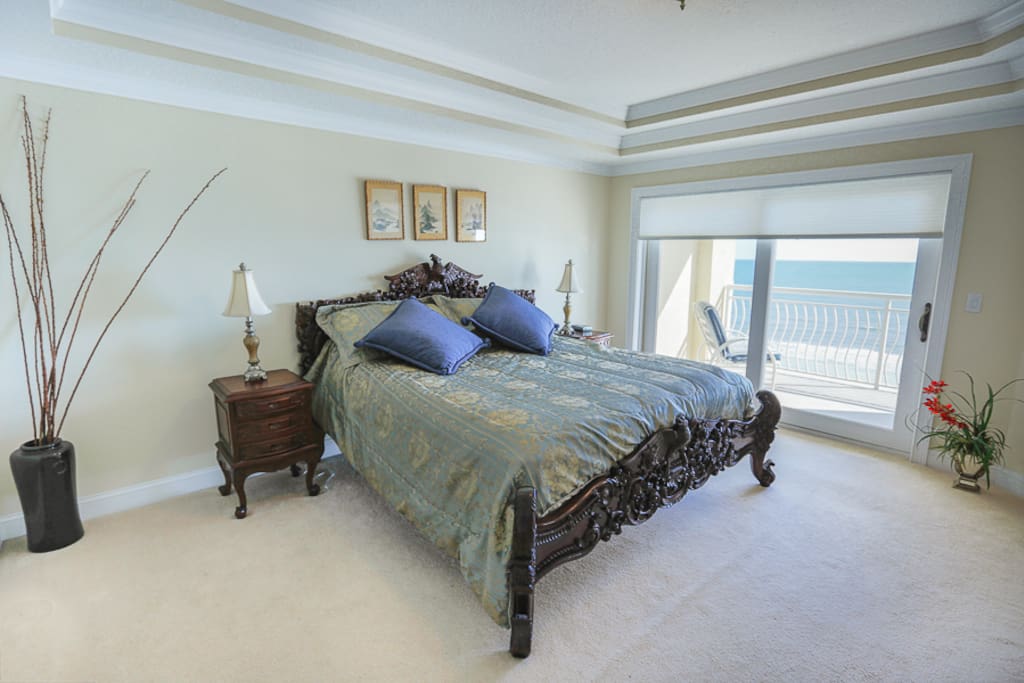 master bedroom overlooking balcony and ocean