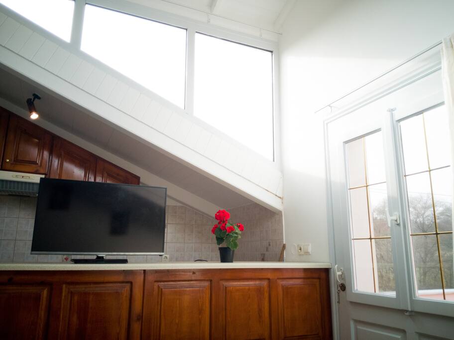 Tv at living room, kitchen bar