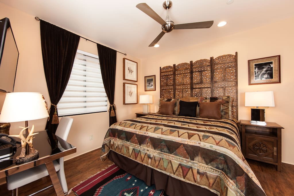 This luxurious master bedroom has a king sized bed, HDTV, IPod dock, desk, and a large closet.