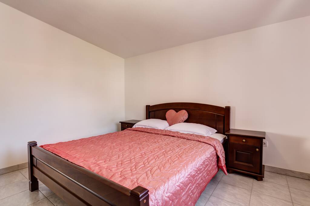 Bedroom 1 with comfortable double bed with night stands next to the bed.