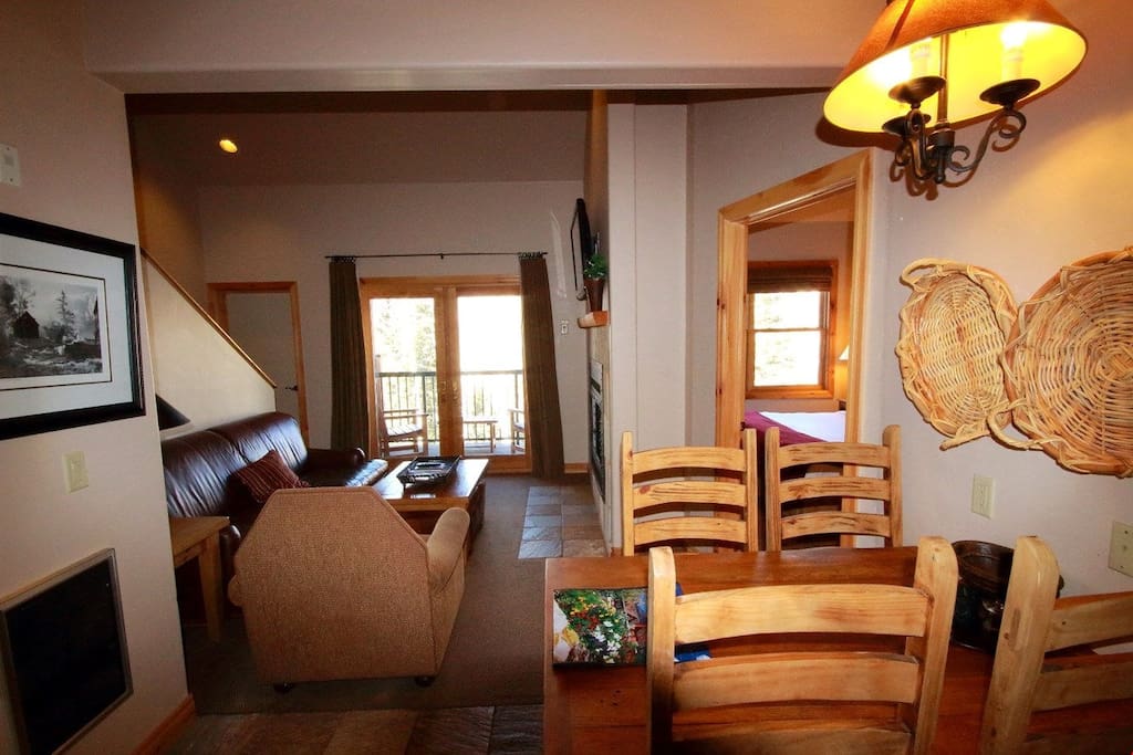 The luxurious living room features a fireplace and a balcony.