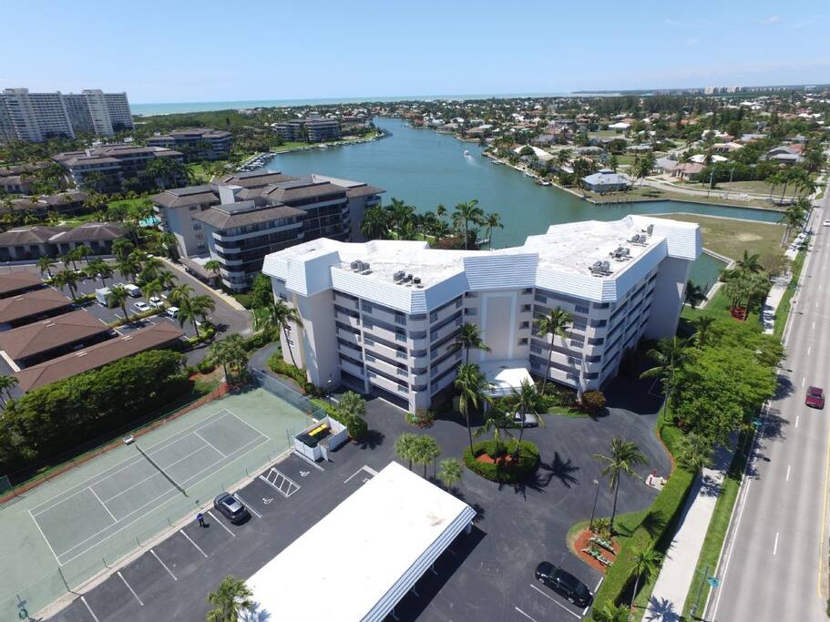 Ariel view of condo with Clam Bay and Gulf of Mexico in background.