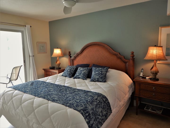 The master bedroom has a pillow-top king bed, A/C, HDTV, ensuite bath with walk-in shower and private screened in balcony with cove views.