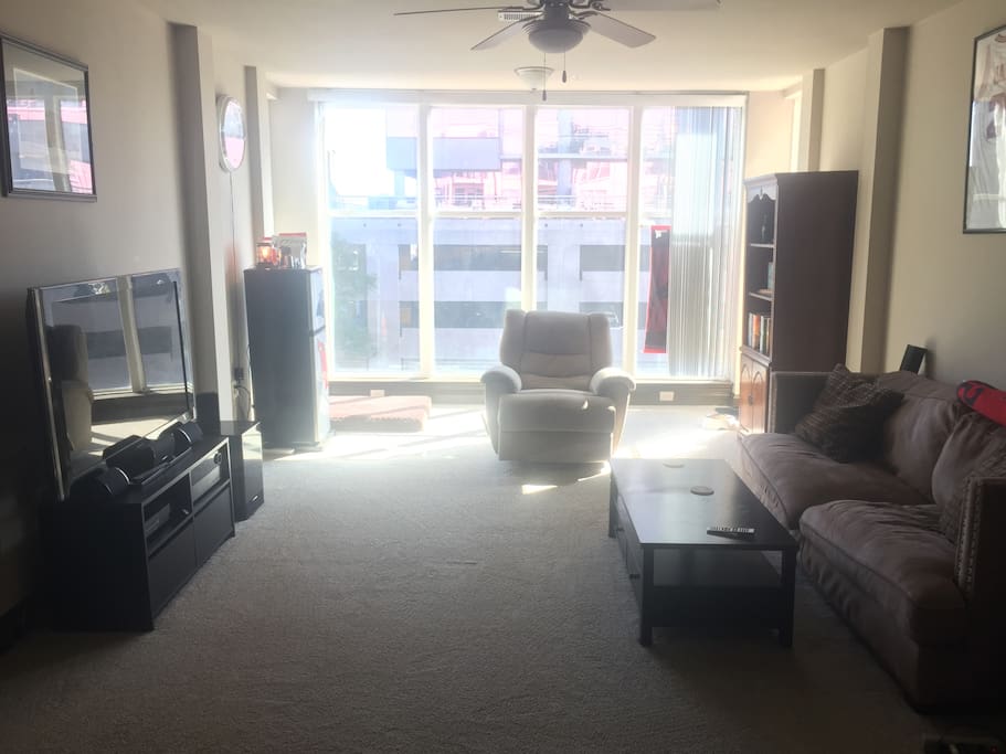 Living room with entertainment station, couch, and plenty of space.