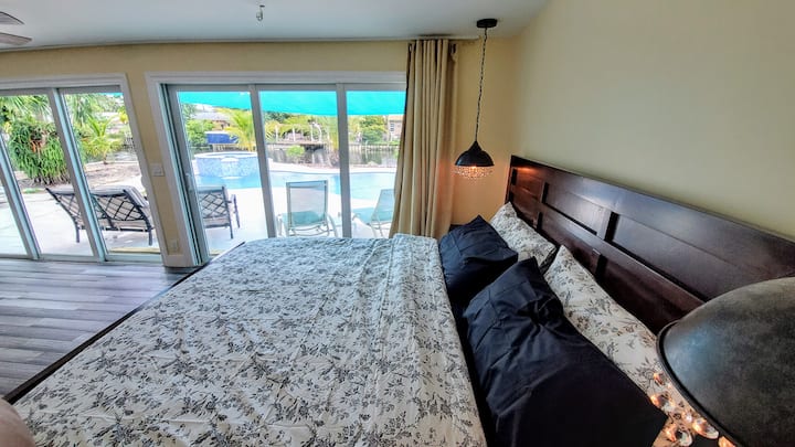 View to the Pool and Gulf Stream from the King Bed in the  Master Bedroom