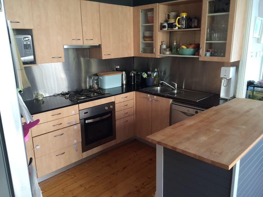 Kitchen with oven, dishwasher, microwave.