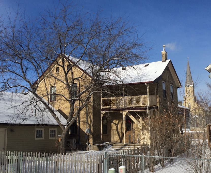 The south side of the home shows indicates historical use of the home as both a single family and two family home during it's 120 year history. In the background is the Guardian Angles Roman Catholic Church built by German immigrants circa 1888.
