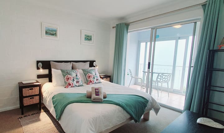 Bedroom with access to  enclosed balcony and stunning views. 