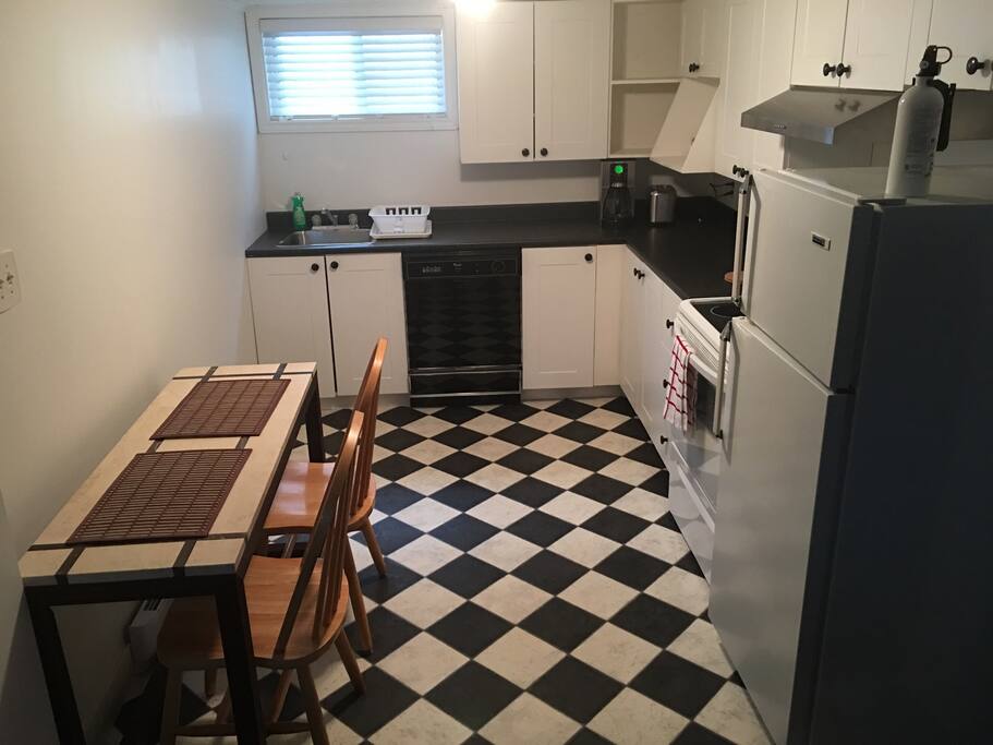 Kitchen with coffee maker, toaster, fridge and oven