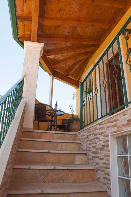 The stairs lead up to the balcony and entrance of the main house.
