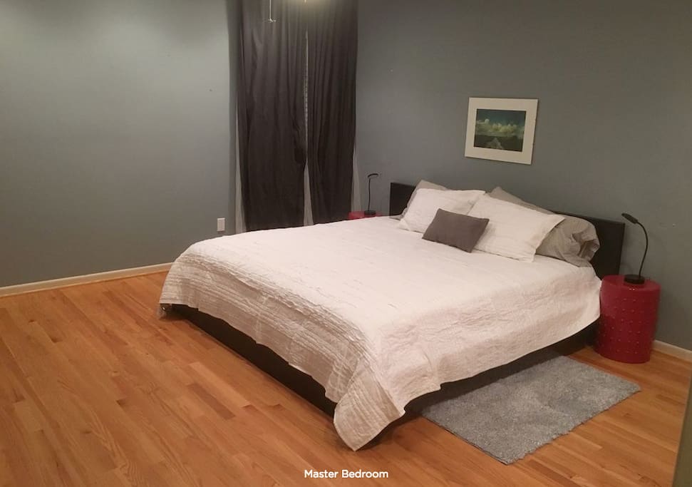King size bed in master with doors to the rear deck with hot tub.