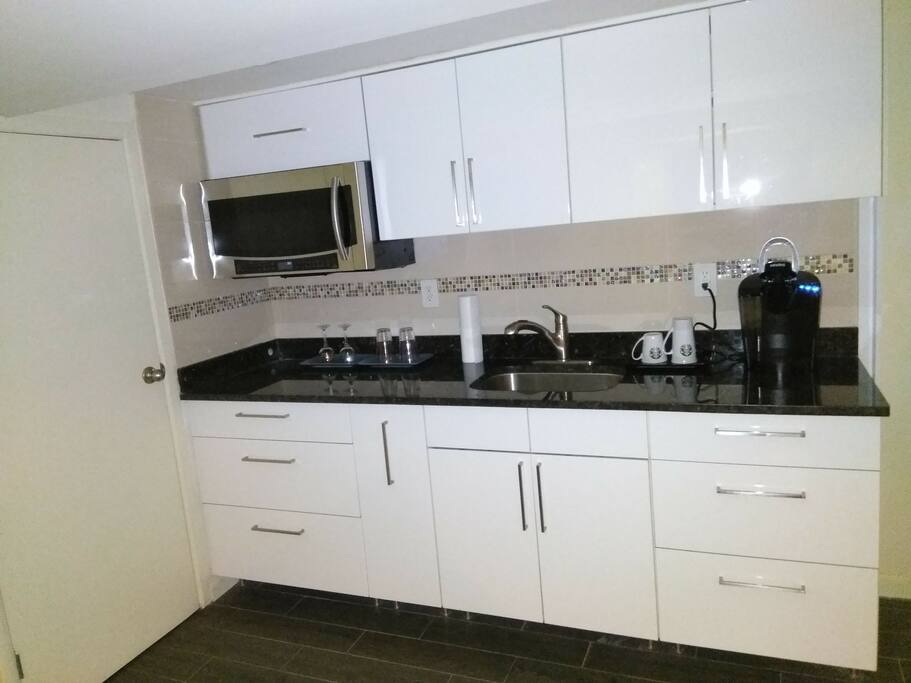 Kitchen with Keurig coffee maker and complimentary coffee and herbal tea