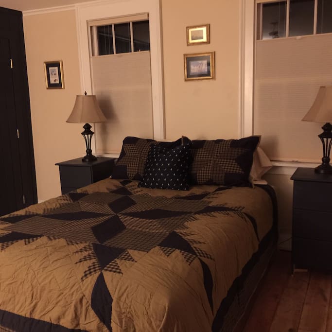 Ground floor Admiral's Quarters, queen size bed, wing chair for reading and relaxing.