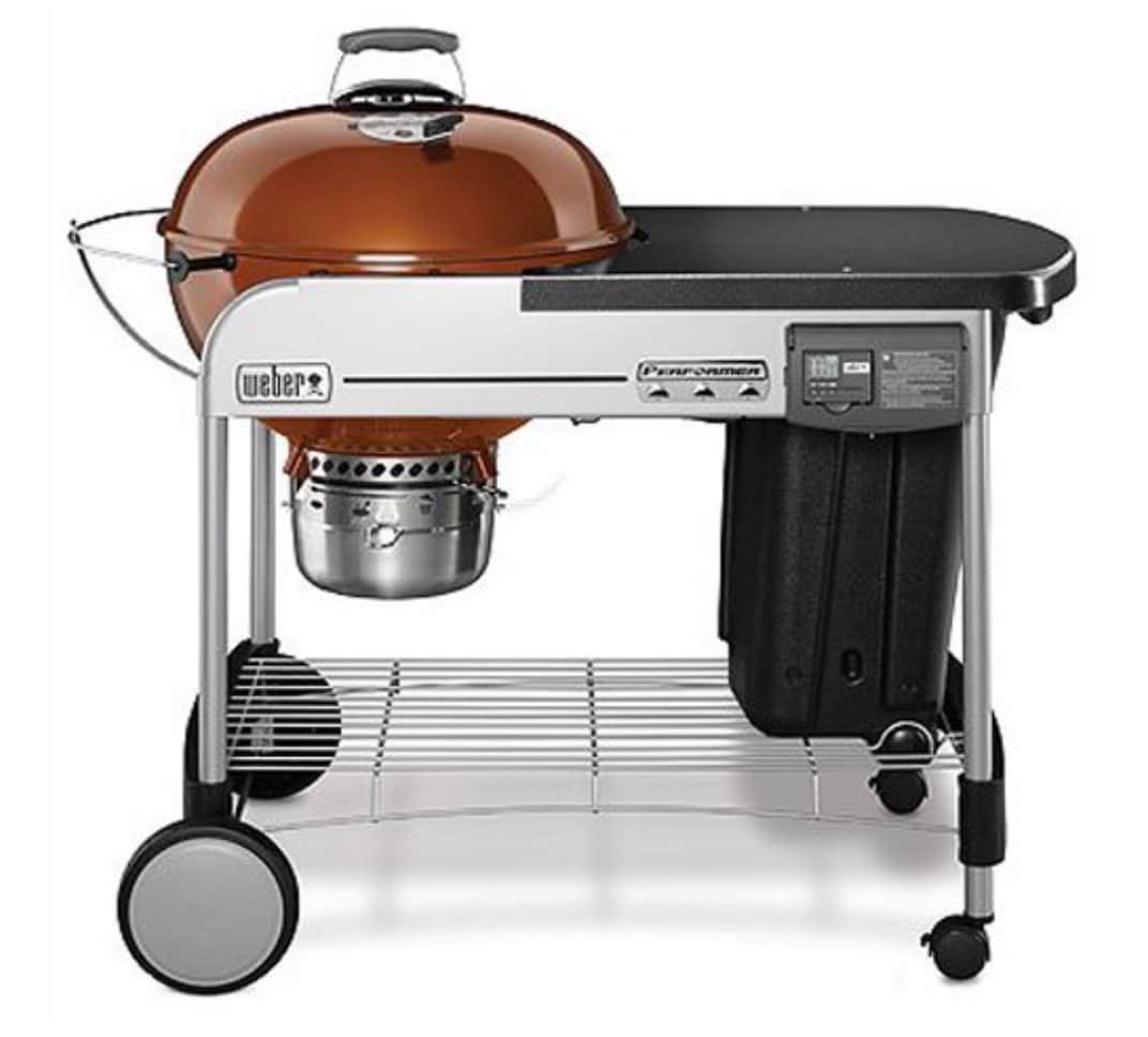 A functional outdoor grill is shown on a sturdy metal cart. The grill features a rounded, glossy brown lid with a built-in thermometer and an attached handle. A lower shelf provides additional storage, and wheels allow for easy mobility.