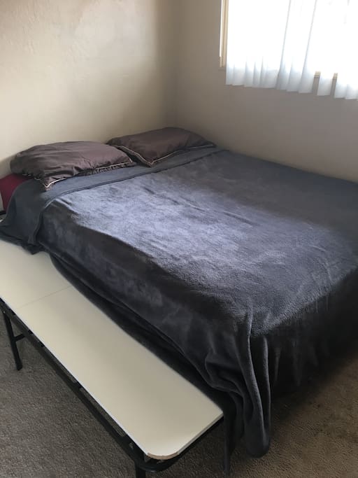 This is the Queen bed reserved for guests. Fresh sheets, fluffed pillows and a soft blanket are placed on just before your arrival to ensure cleanliness.