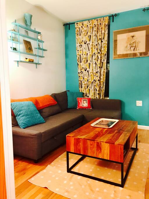 Confortable Ikea L shaped couch and coffee table that pops up for comfortable eating.