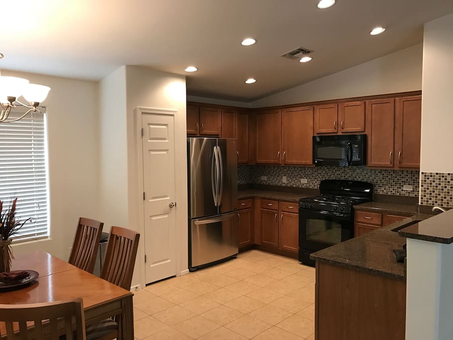 The kitchen features granite, gas range, and brand new LG refrigerator.