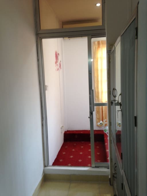 Entrance to bathroom, wardrobe on the right side, with AC.