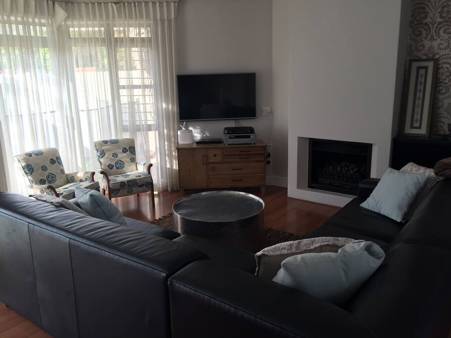 Lounge with fireplace and TV.