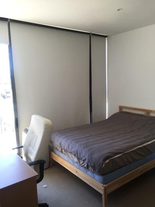 Queen sized bed with private balcony and a study