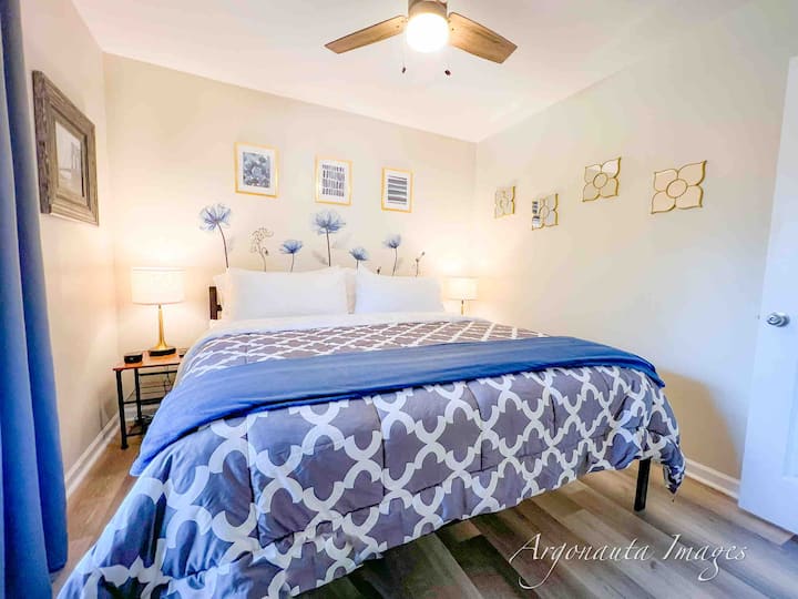 The front bedroom boasts a king bed, smart tv, and closet with plenty of storage, and extra room under the bed for large suitcases.