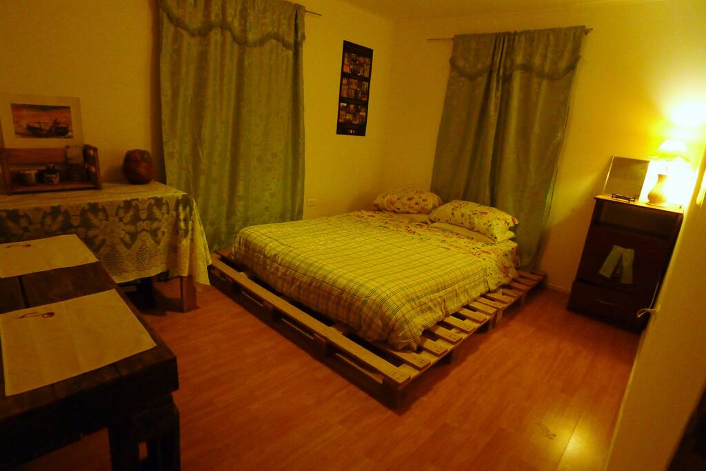 Bright and colourful room, with table and some furniture to store your things.