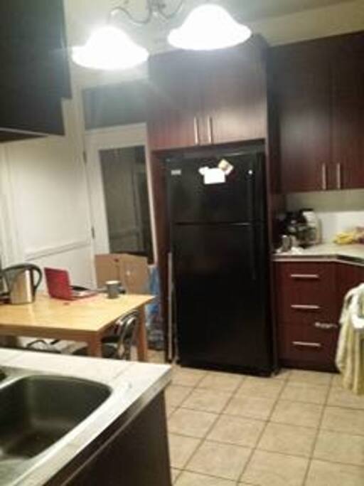 The Kitchen. One shelf in the fridge and one cupboard will be reserved for you.