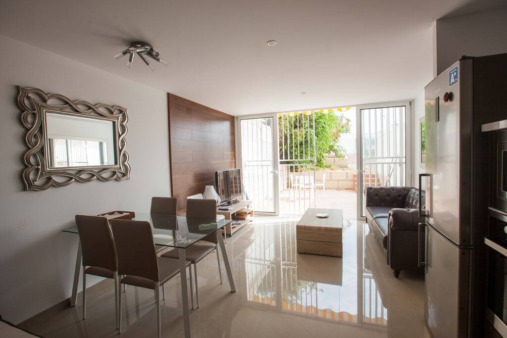 Living room space merged with kitchen