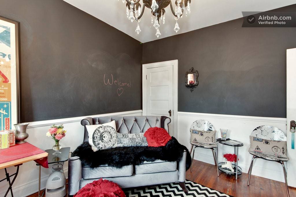 Art from famous pop artist inspire fun and style. The black walls are painted with chalkbord paint so you can write all over the room should you wish!