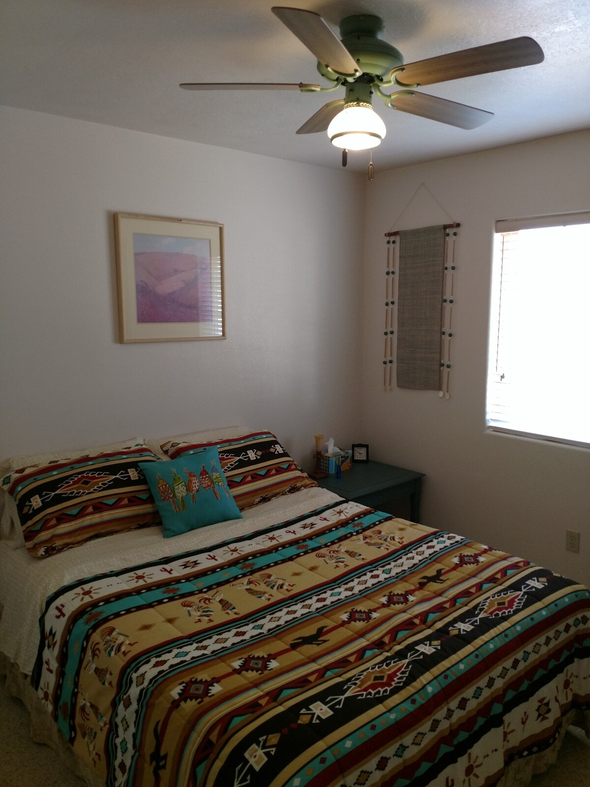 Chumba cha kulala cha mgeni wa tatu kilicho na kitanda cha godoro cha juu cha godoro pamoja na meza ya mwisho.