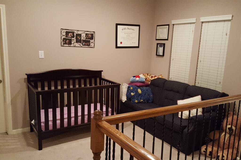 Upstairs hallway with sofa and crib