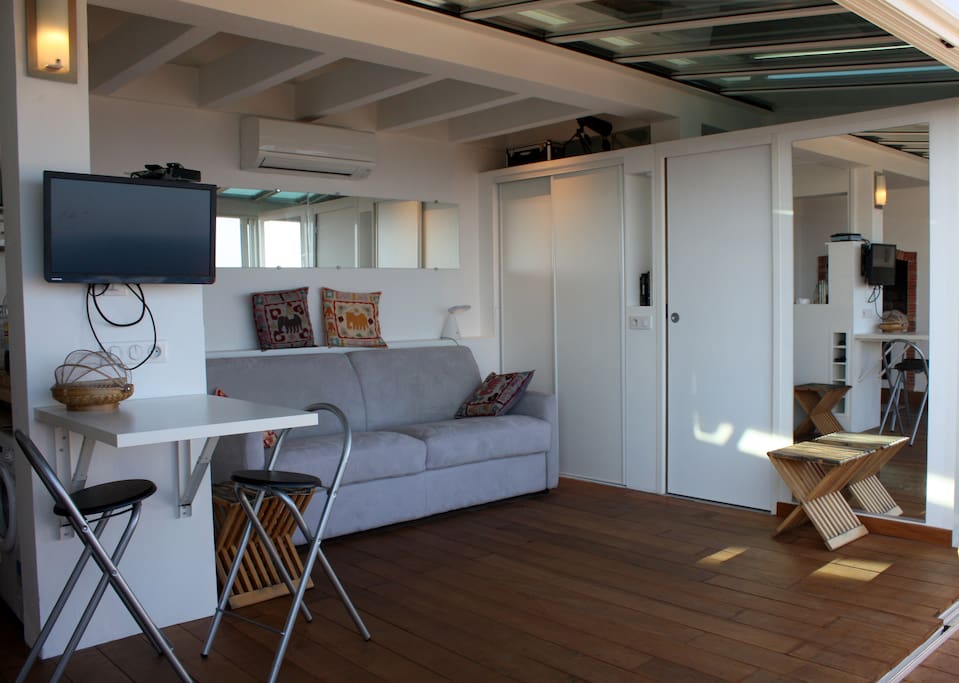living space with sofa and air conditioning