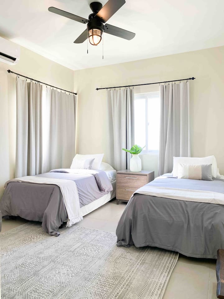 The guest room at The Lena has two twin size beds.