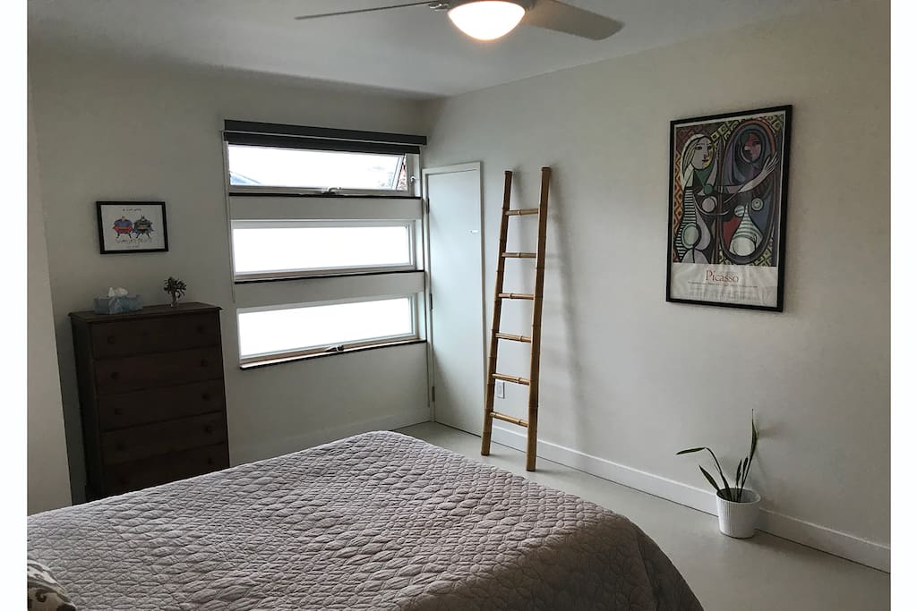 Plenty of natural light in the bedroom, with dark window coverings for sleeping in.