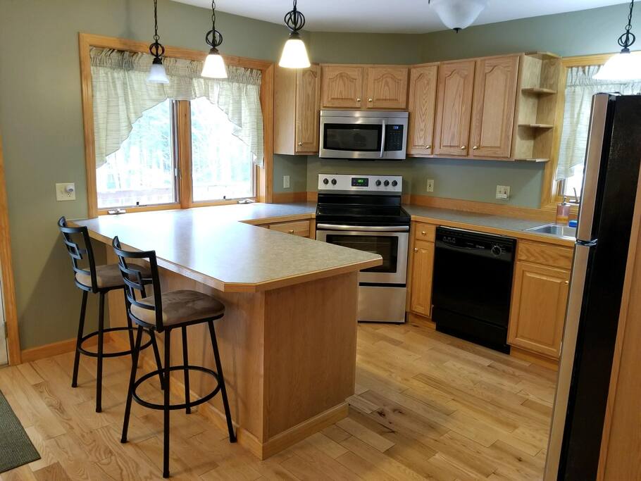 Kitchen with dishwasher, fridge, oven, microwave, coffee maker, blender and toaster. All dishes, pots, pans, utensils included.