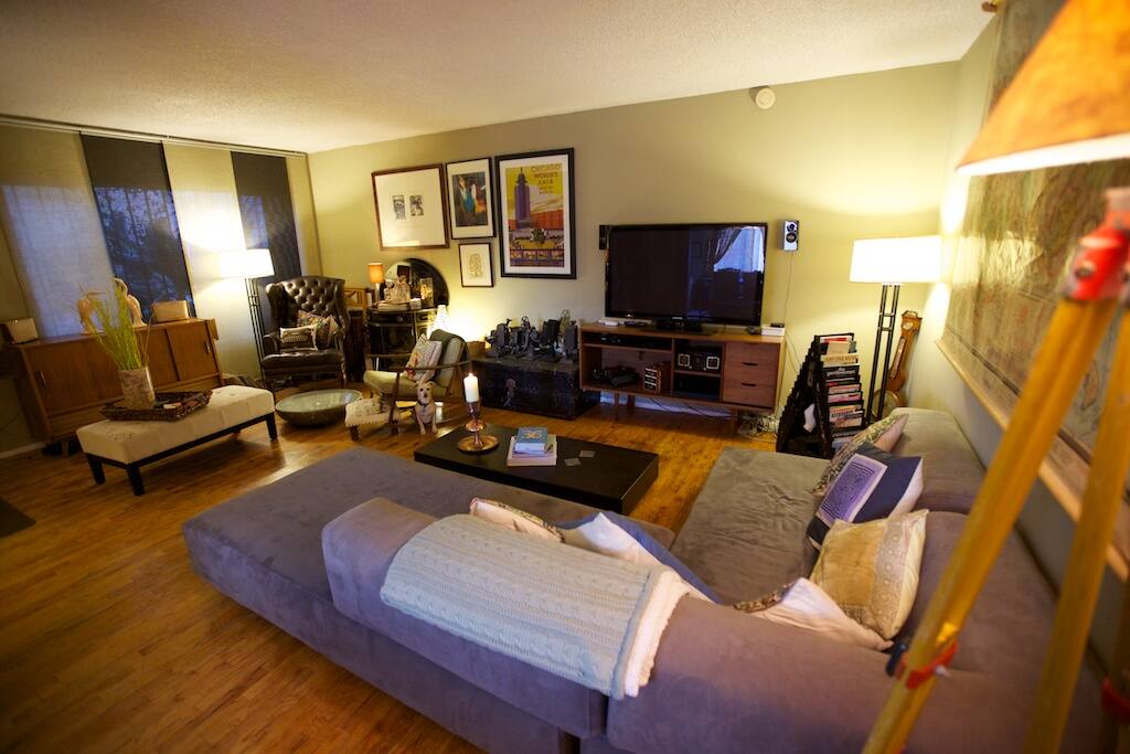 Our roomy and arty living room has couches and comfort for days but the sophistication of antique furniture and rich dark leather.