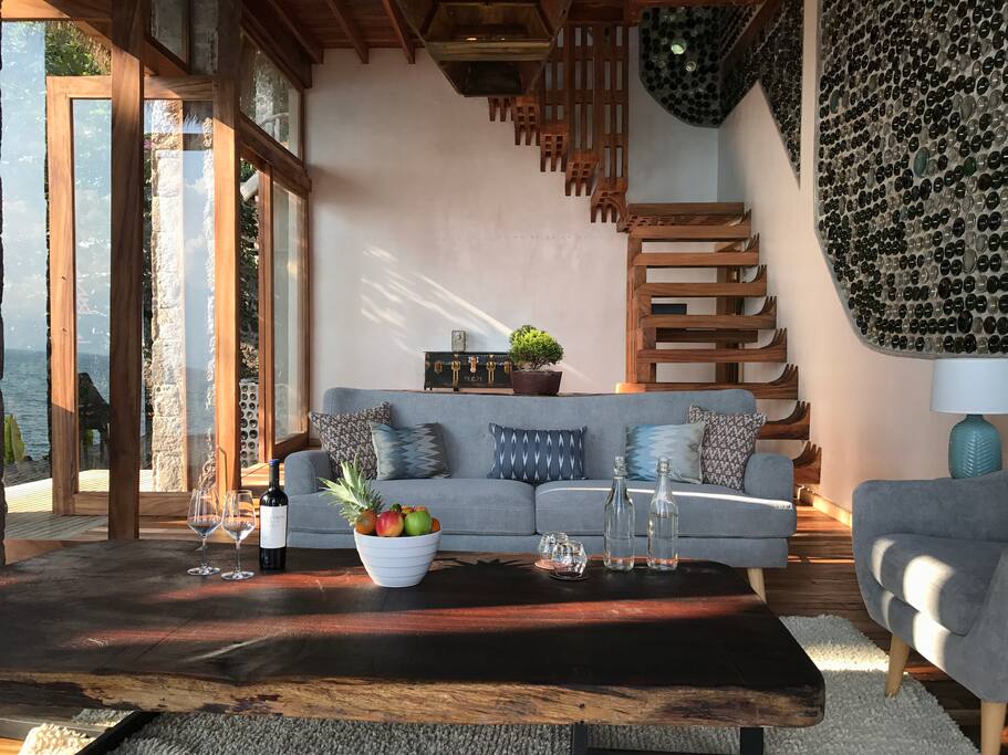 First floor living room facing volcano and lake with feature bottle wall.