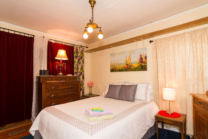 Bedroom~ One private bedroom with lovely antiques, ample place to put your clothes. Curtain light occluding for your sleeping pleasure. Removable panels kept for med staff working night. Host can remove upon your request. QUEEN BED SLEEPS 2
