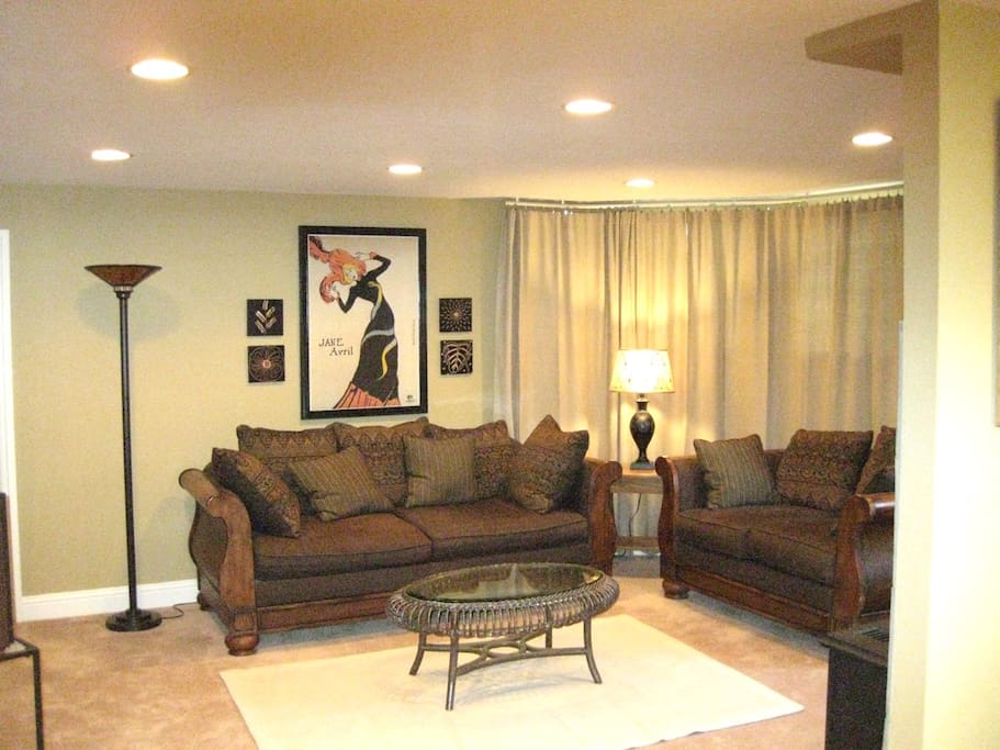 Comfy couches and floor to ceiling drapes for privacy