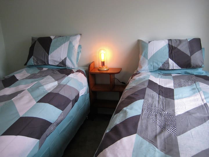 غرفة نوم ثانية بسرير بحجم كبير يمكن تحويله إلى سريرين فرديين.